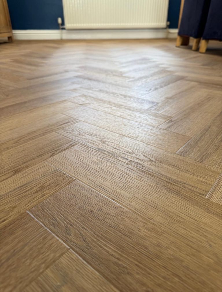 Wood effect vinyl floor with a red sofa